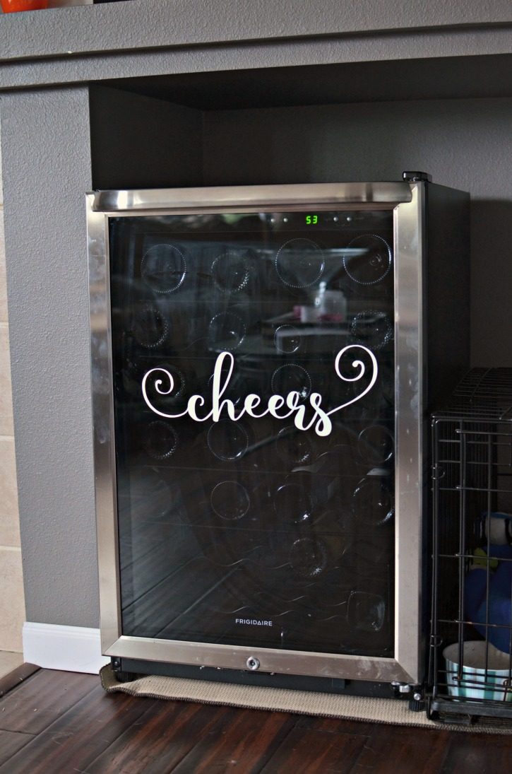 Vinyl Decal of "cheers" on a wine fridge