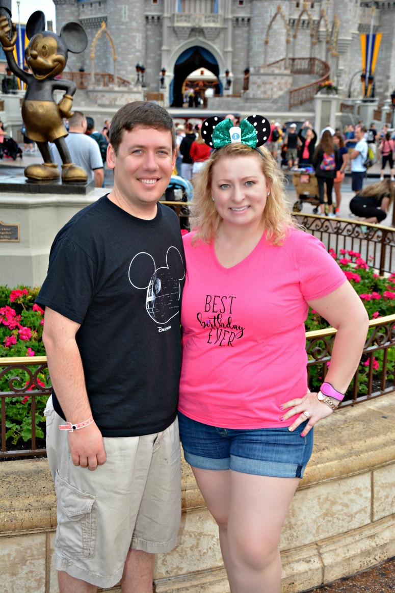 Couple at Magic Kingdom in front of the castle