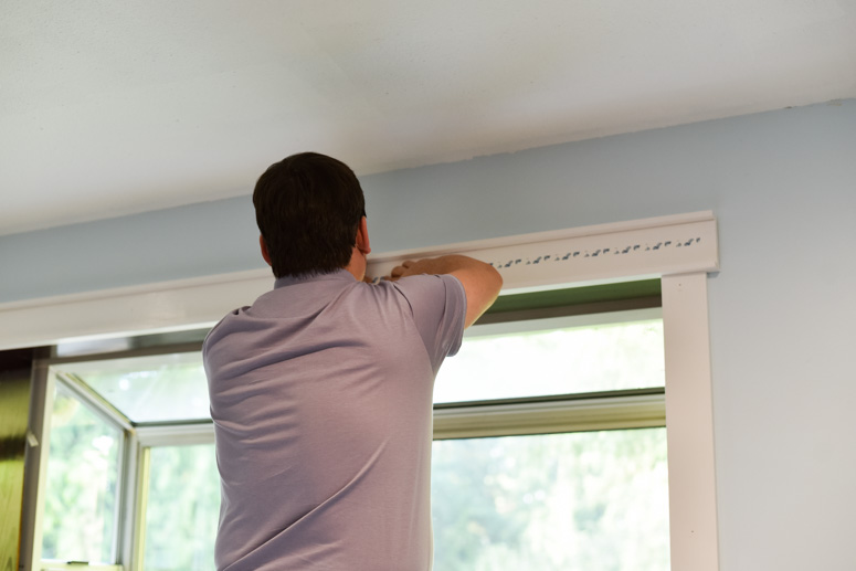 Man installing tape for Duck Weatherization