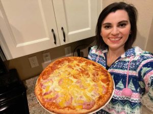 Woman holding Papa's Purfect Pizza