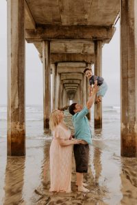 Family under an ocean pier