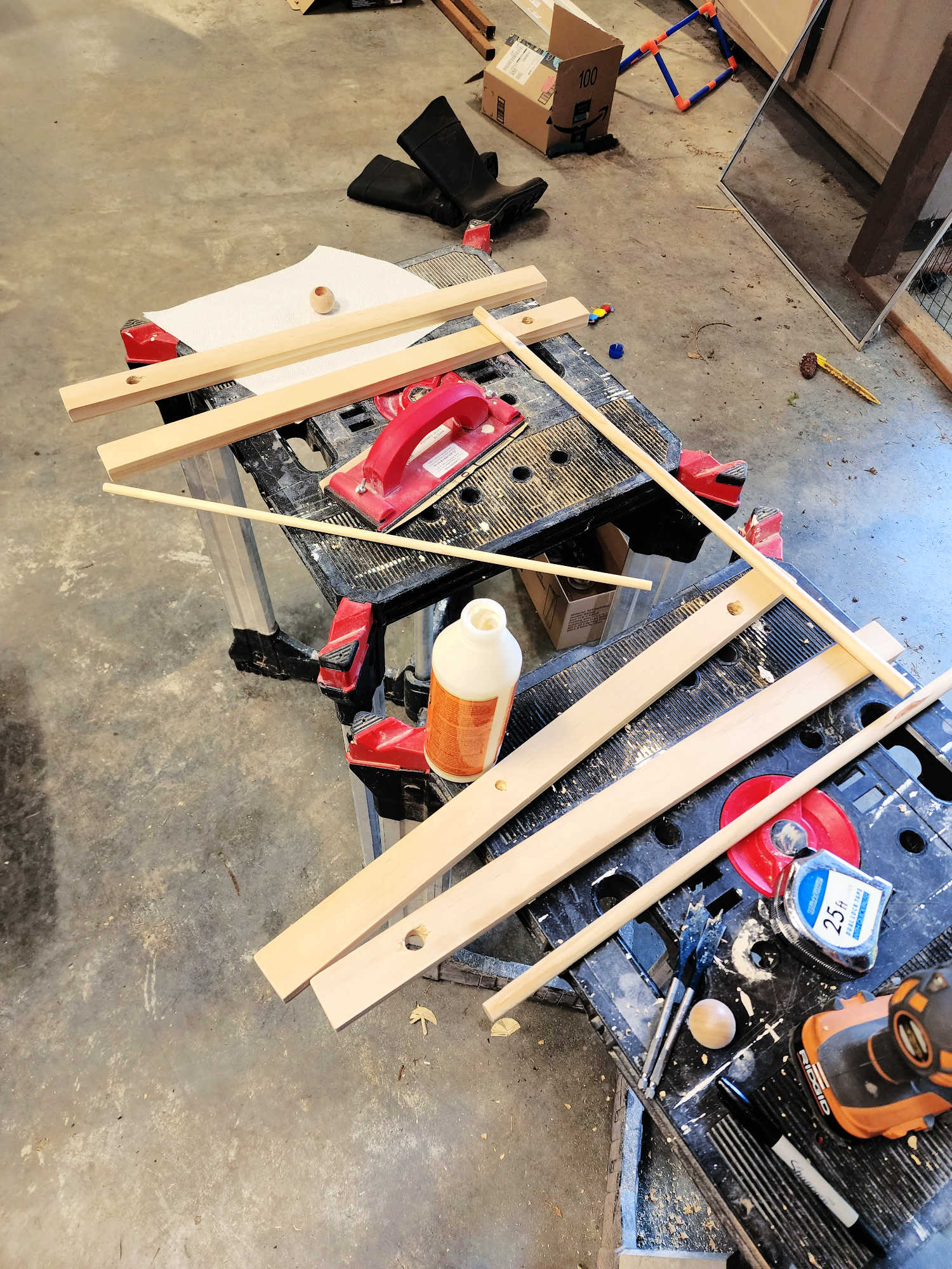 Wood pieces sit on a sawhorse in a workshop